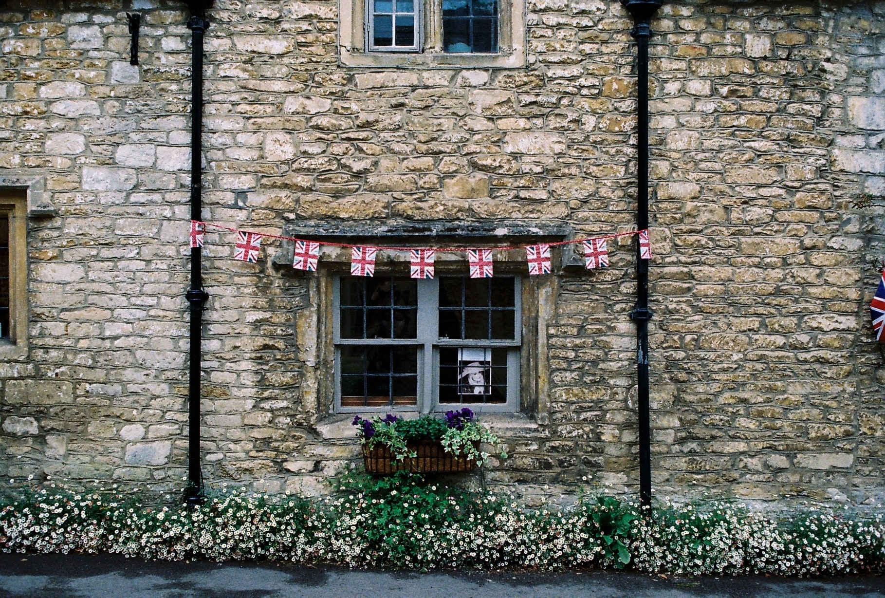 Union Jack flying on a traditional english cottage